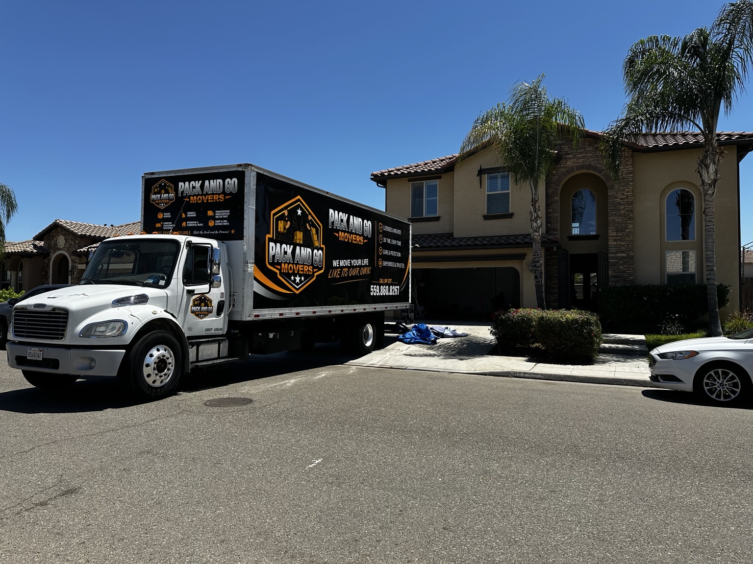 Pack And Go branded moving truck outside a Fresno residential move