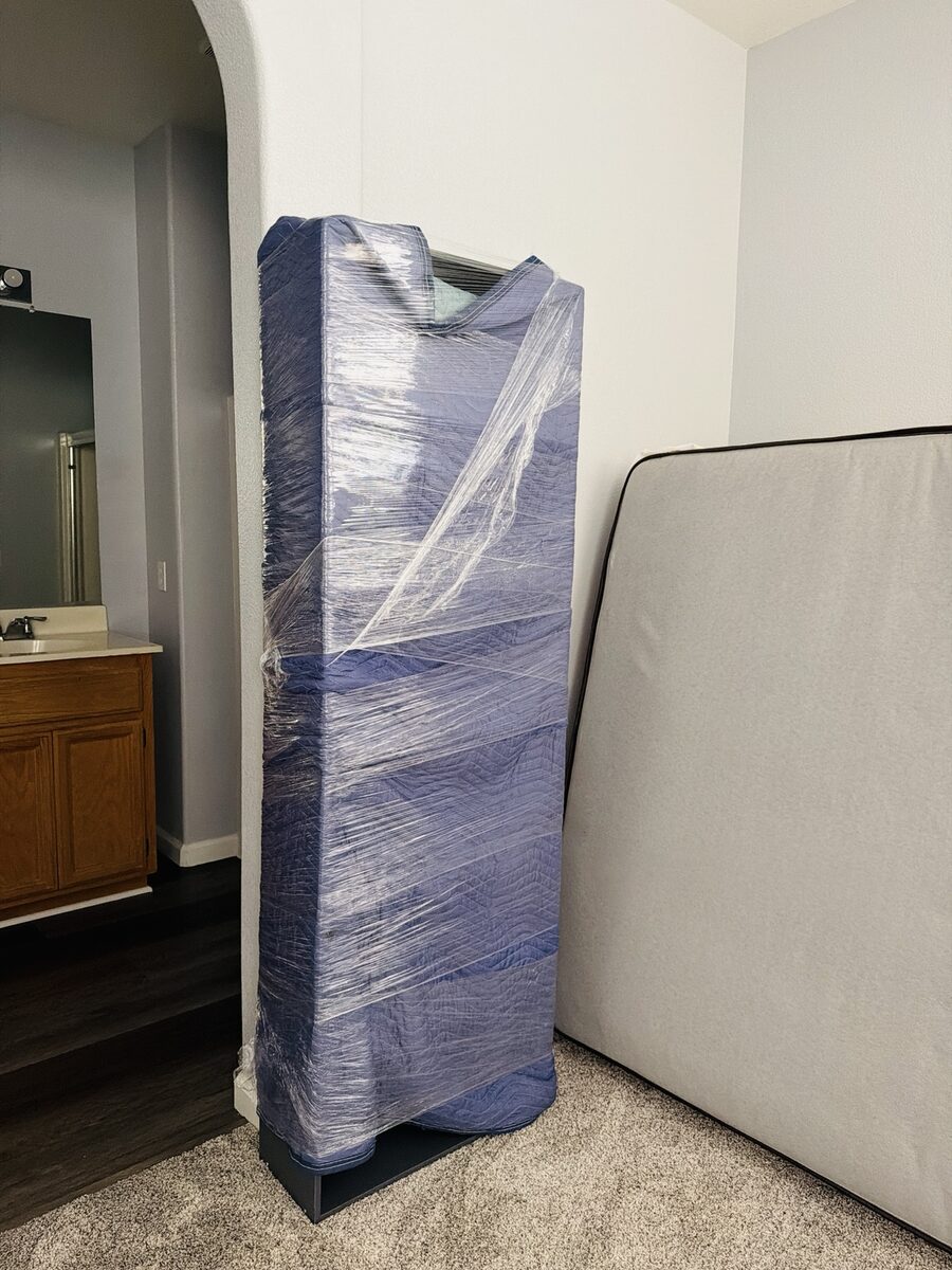 Furniture protected with moving blankets and stretch wrap before transport